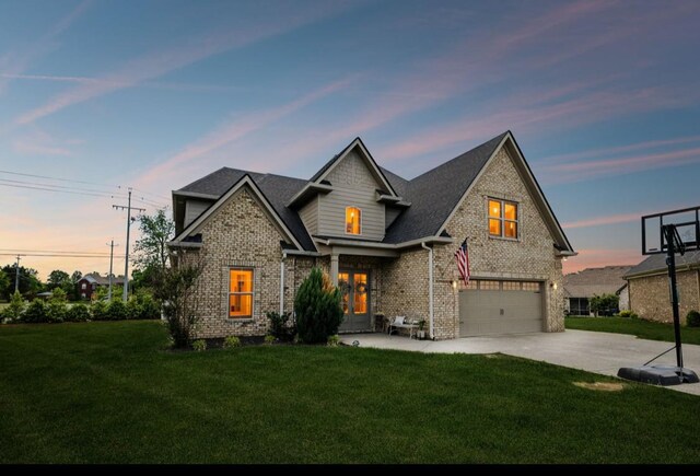 view of front of property featuring a garage, a front yard, french doors, concrete driveway, and brick siding