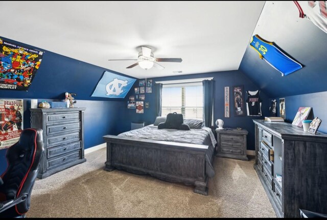 bedroom with carpet floors, lofted ceiling, ceiling fan, and baseboards