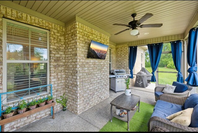 view of patio featuring area for grilling, ceiling fan, and an outdoor living space