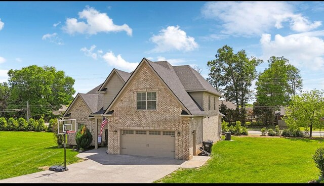 view of front of home featuring brick siding, concrete driveway, a front yard, a garage, and a shingled roof