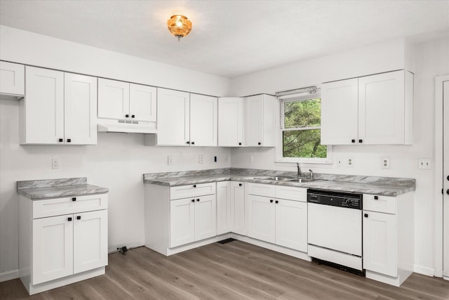 kitchen with dishwasher, a sink, under cabinet range hood, and wood finished floors