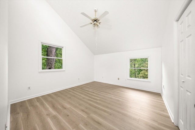 bonus room featuring lofted ceiling, light wood-style flooring, ceiling fan, and baseboards