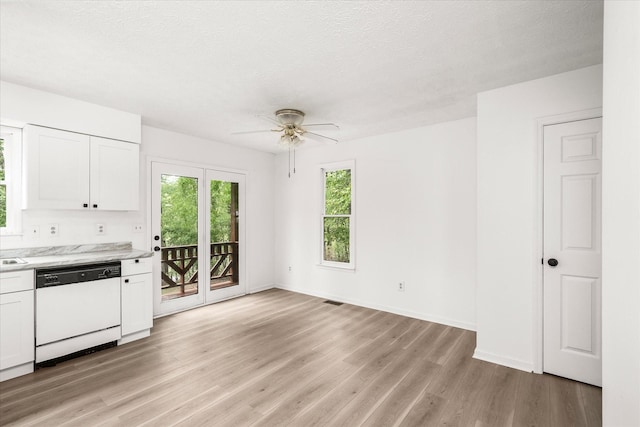 kitchen featuring dishwasher, ceiling fan, light wood finished floors, white cabinetry, and baseboards