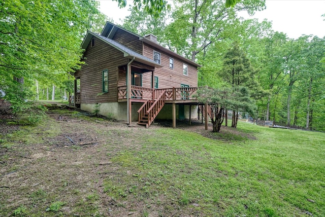 back of house with stairs, a wooden deck, and a yard