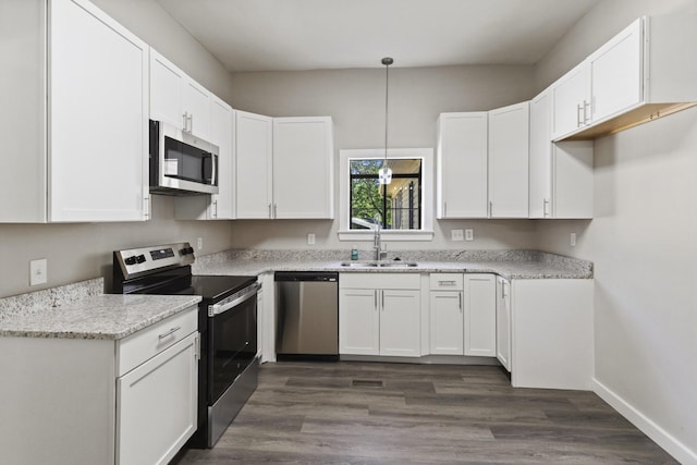 1405 W Lincoln St, Tullahoma, TN 37388 - kitchen with stainless steel appliances, a sink, white cabinetry, and decorative light fixtures