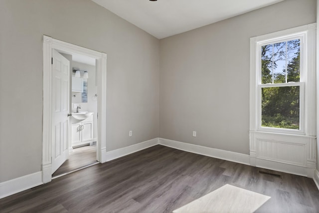 1405 W Lincoln St, Tullahoma, TN 37388 - empty room with plenty of natural light, dark wood-style flooring, and baseboards
