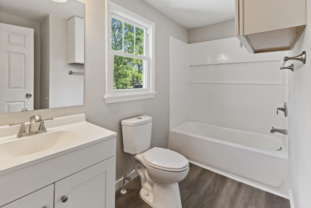1405 W Lincoln St, Tullahoma, TN 37388 - bathroom with wood finished floors, toilet, vanity, baseboards, and  shower combination
