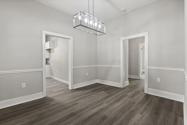 1405 W Lincoln St, Tullahoma, TN 37388 - unfurnished dining area featuring a chandelier, dark wood-style flooring, and baseboards