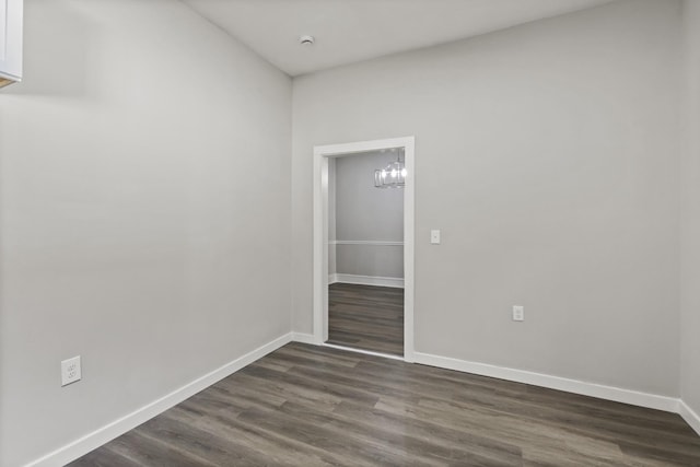 1405 W Lincoln St, Tullahoma, TN 37388 - unfurnished room with dark wood-style flooring, baseboards, a chandelier, and a smoke detector