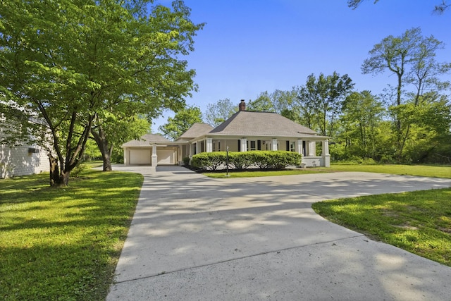 1405 W Lincoln St, Tullahoma, TN 37388 - farmhouse-style home with driveway, a front yard, an attached garage, and a chimney