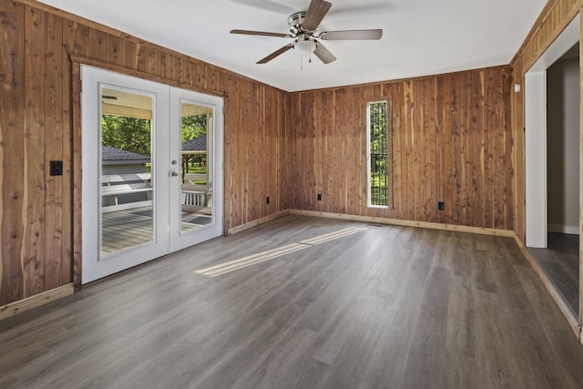 1405 W Lincoln St, Tullahoma, TN 37388 - spare room featuring french doors, wood finished floors, ceiling fan, wood walls, and baseboards