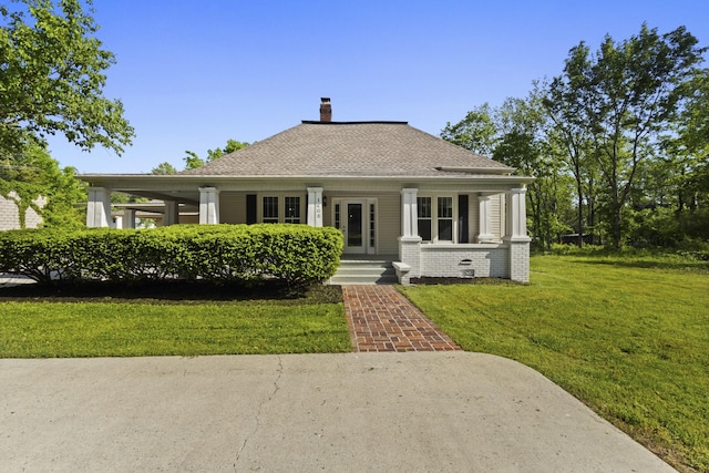 1405 W Lincoln St, Tullahoma, TN 37388 - bungalow-style home with a chimney, a front yard, a porch, and roof with shingles