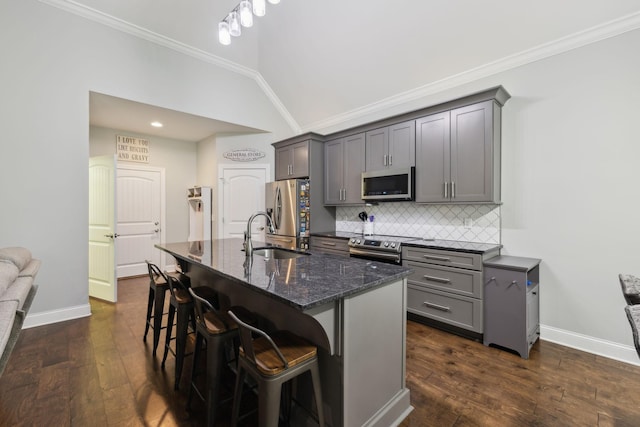 657 Josef Cir, Columbia, TN 38401 - kitchen with stainless steel appliances, gray cabinets, a sink, dark stone counters, and backsplash