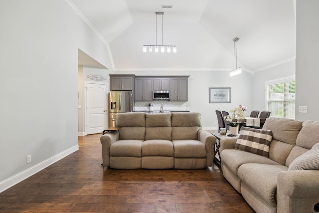 657 Josef Cir, Columbia, TN 38401 - living room with high vaulted ceiling, dark wood-style flooring, baseboards, and crown molding