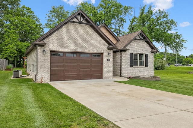657 Josef Cir, Columbia, TN 38401 - view of front of house featuring a garage, central AC, driveway, brick siding, and a front yard