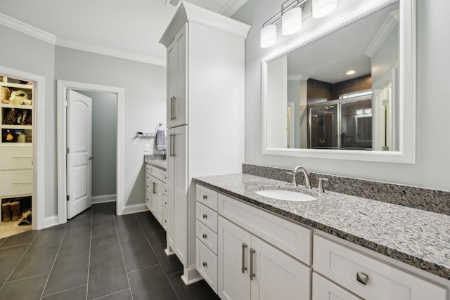 657 Josef Cir, Columbia, TN 38401 - full bathroom featuring a stall shower, vanity, crown molding, tile patterned flooring, and baseboards