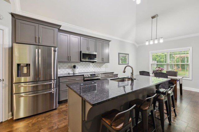 657 Josef Cir, Columbia, TN 38401 - kitchen featuring appliances with stainless steel finishes, a sink, dark wood finished floors, decorative backsplash, and dark stone countertops
