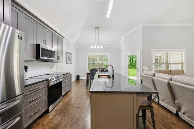 657 Josef Cir, Columbia, TN 38401 - kitchen with stainless steel appliances, a sink, open floor plan, dark stone counters, and decorative backsplash