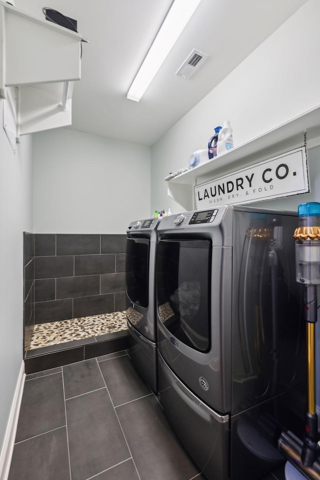 657 Josef Cir, Columbia, TN 38401 - laundry room featuring separate washer and dryer, dark tile patterned floors, and baseboards