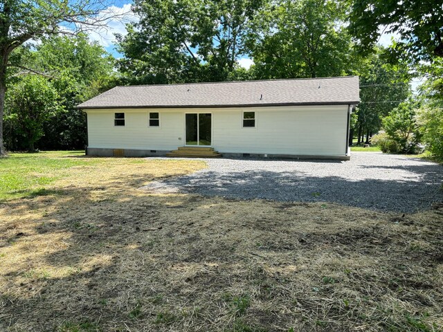 back of property with entry steps and crawl space