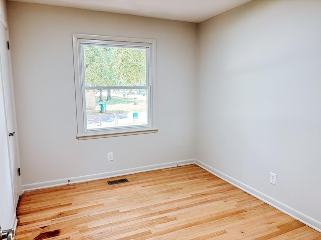 empty room featuring wood finished floors and baseboards