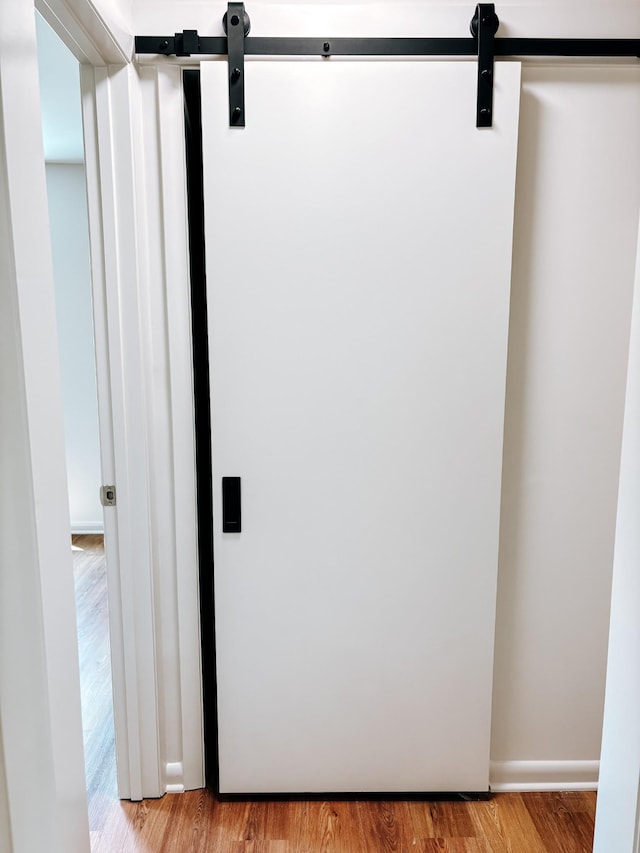 detailed view of a barn door and wood finished floors