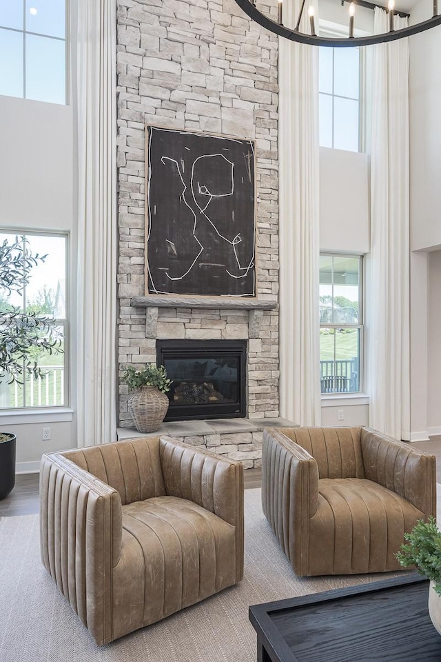 9016 Nestling Ridge Ct, College Grove, TN 37046 - living area featuring a fireplace, a towering ceiling, healthy amount of natural light, baseboards, and wood finished floors