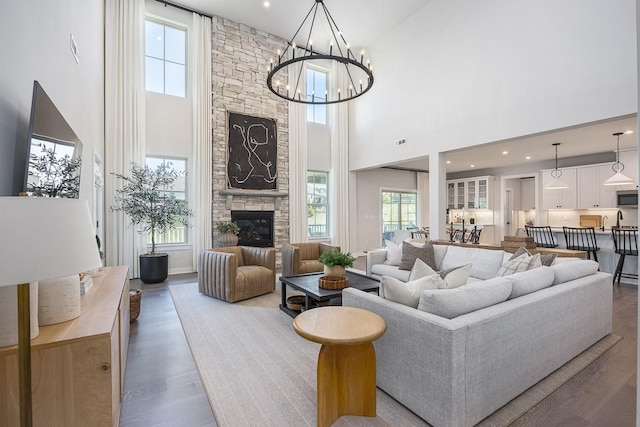 9016 Nestling Ridge Ct, College Grove, TN 37046 - living area with a high ceiling, wood finished floors, a chandelier, and a fireplace