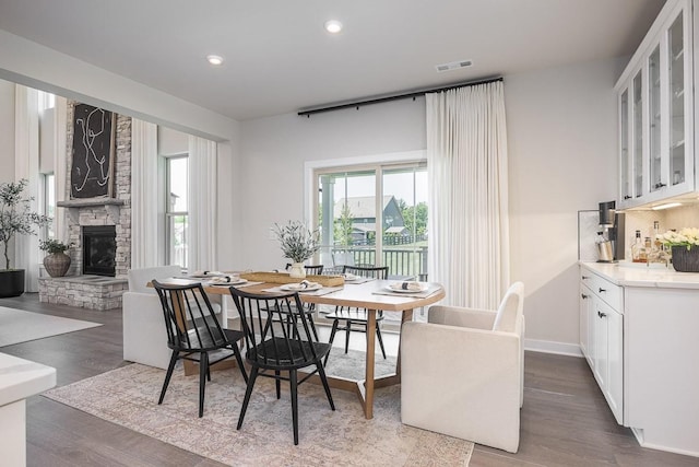 9016 Nestling Ridge Ct, College Grove, TN 37046 - dining space featuring wood finished floors, a fireplace, recessed lighting, baseboards, and bar