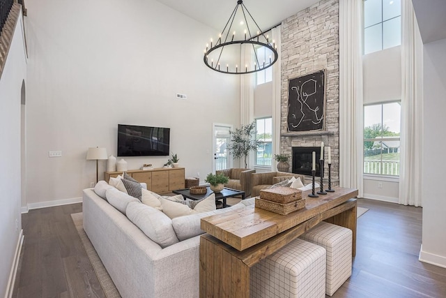 9016 Nestling Ridge Ct, College Grove, TN 37046 - living area featuring a fireplace, a high ceiling, dark wood-style floors, baseboards, and a chandelier