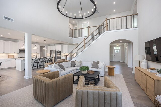 9016 Nestling Ridge Ct, College Grove, TN 37046 - living room with arched walkways, a high ceiling, wood finished floors, baseboards, and recessed lighting
