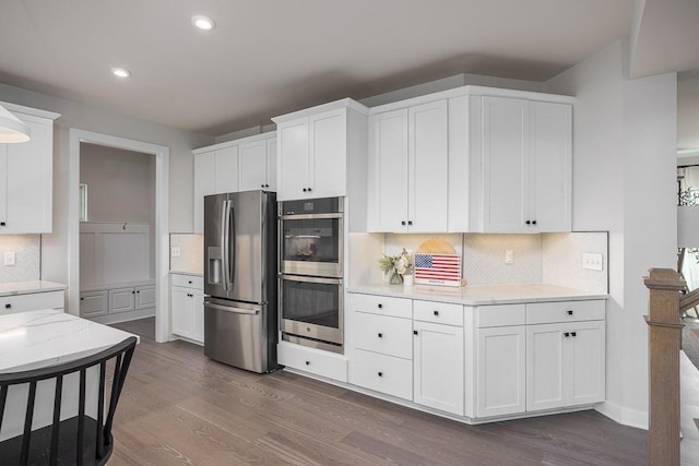 9016 Nestling Ridge Ct, College Grove, TN 37046 - kitchen with appliances with stainless steel finishes, dark wood-type flooring, decorative backsplash, recessed lighting, and white cabinets