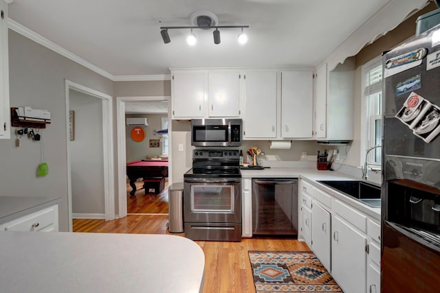 110 Marita Ave, Goodlettsville, TN 37072 - kitchen with appliances with stainless steel finishes, a sink, light wood-style flooring, white cabinetry, and light countertops