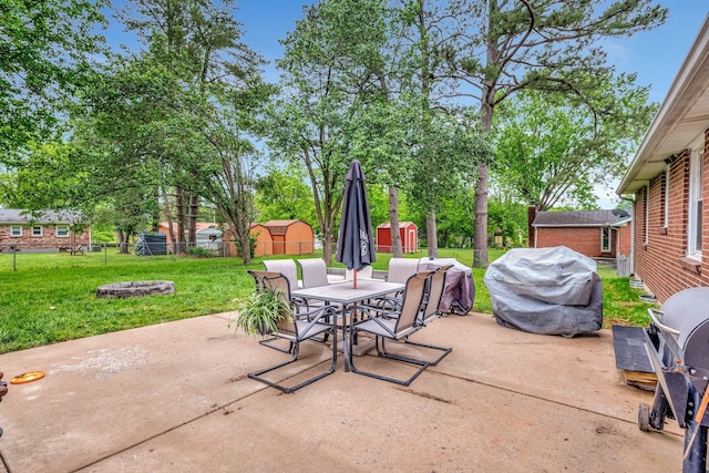 110 Marita Ave, Goodlettsville, TN 37072 - view of patio / terrace with outdoor dining area, a storage shed, area for grilling, an outdoor fire pit, and an outbuilding