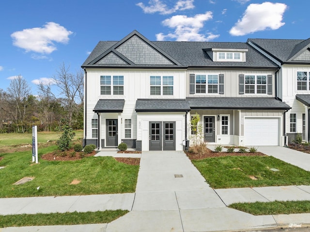 672 Tulip Springs Ct, Hermitage, TN 37076 - view of front of house featuring board and batten siding, driveway, and a front lawn