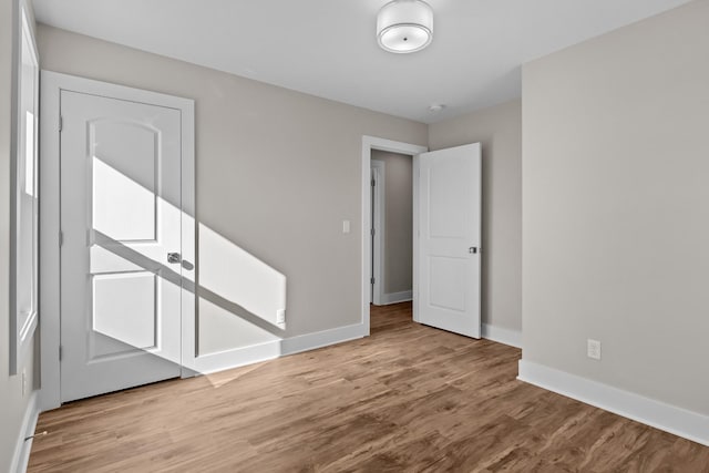 empty room with wood finished floors and baseboards