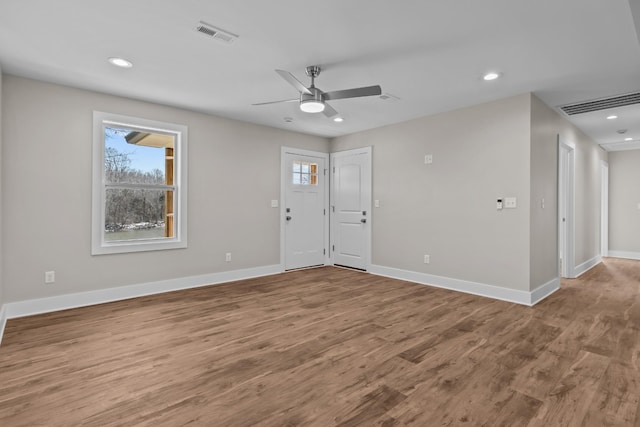 spare room with baseboards, recessed lighting, a ceiling fan, and wood finished floors