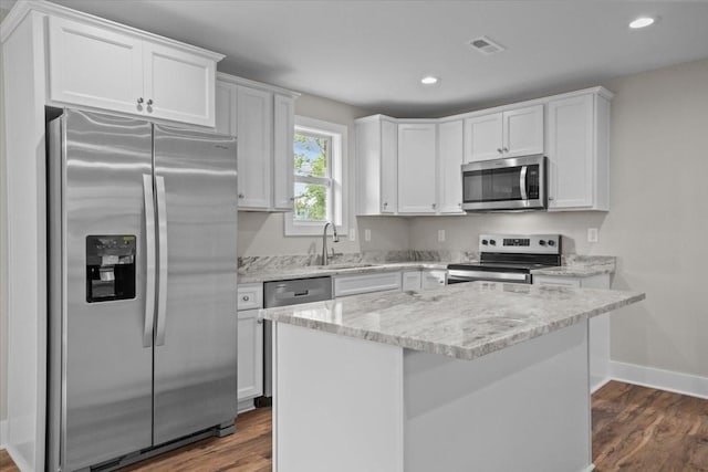 1024 Evans Rd, Burns, TN 37029 - kitchen with appliances with stainless steel finishes, a sink, white cabinetry, baseboards, and dark wood-style flooring