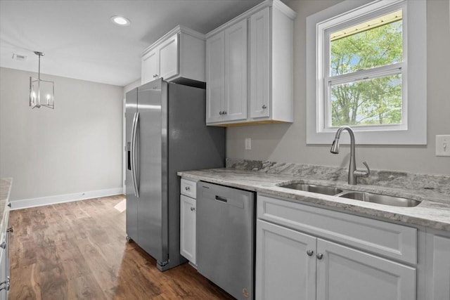 1024 Evans Rd, Burns, TN 37029 - kitchen with stainless steel appliances, a sink, white cabinetry, dark wood-style floors, and light stone countertops
