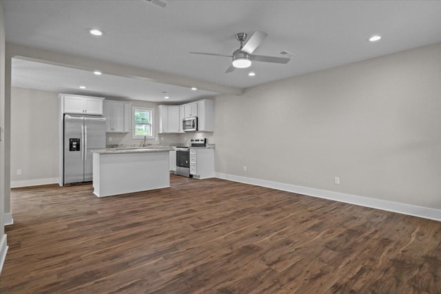 1024 Evans Rd, Burns, TN 37029 - kitchen featuring appliances with stainless steel finishes, baseboards, dark wood-type flooring, white cabinetry, and open floor plan