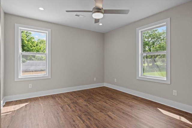 1024 Evans Rd, Burns, TN 37029 - empty room with healthy amount of natural light, wood finished floors, baseboards, and recessed lighting