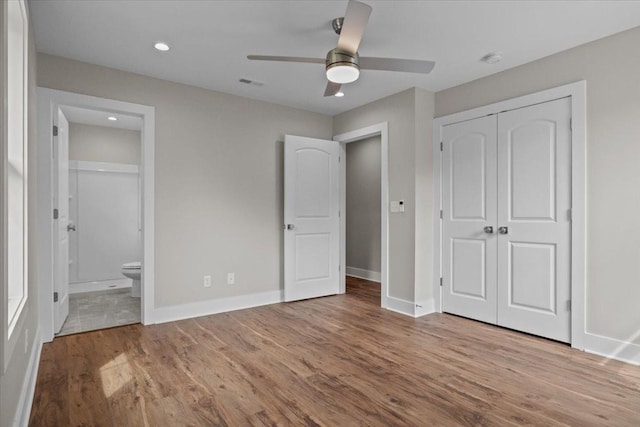 1024 Evans Rd, Burns, TN 37029 - unfurnished bedroom featuring wood finished floors, connected bathroom, baseboards, a closet, and recessed lighting