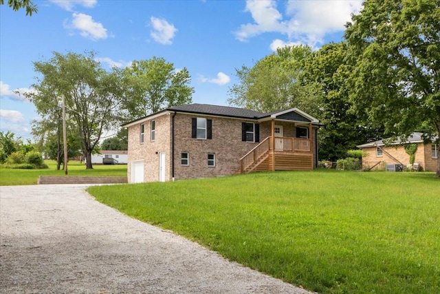 1024 Evans Rd, Burns, TN 37029 - view of front of house featuring gravel driveway, an attached garage, a front yard, and brick siding