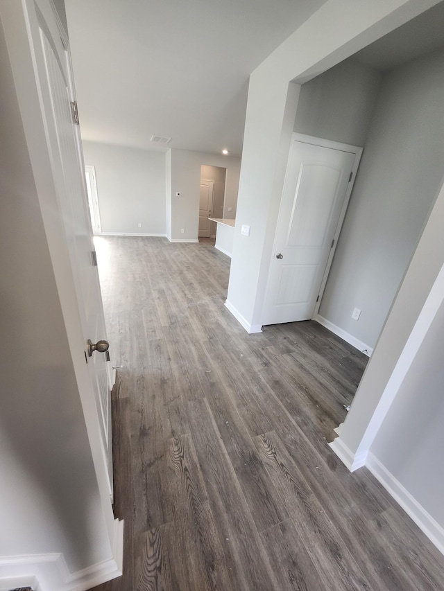 unfurnished room featuring dark wood finished floors and baseboards