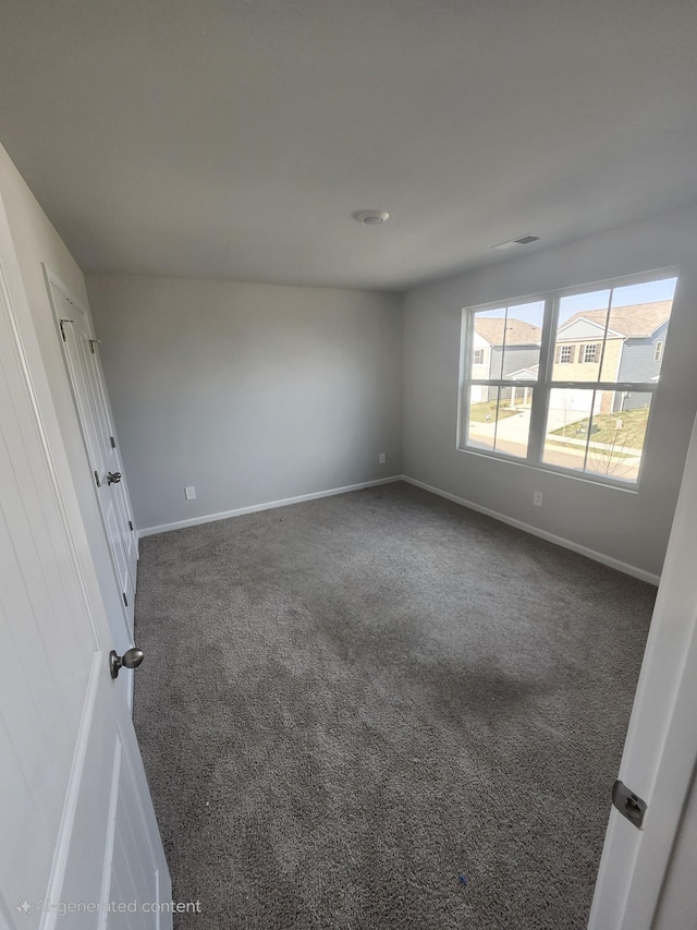 spare room with carpet floors and baseboards