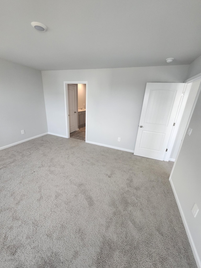 unfurnished bedroom featuring baseboards and carpet