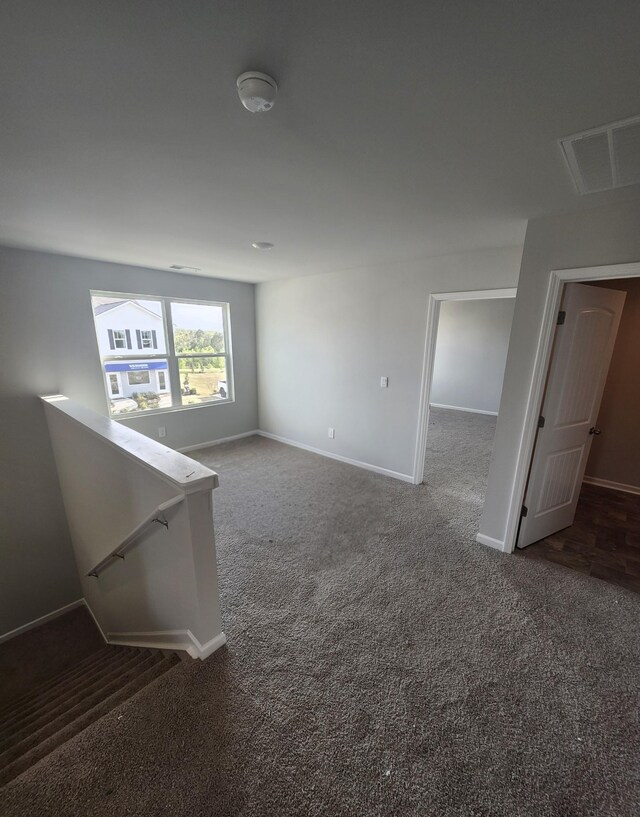 spare room with carpet and baseboards