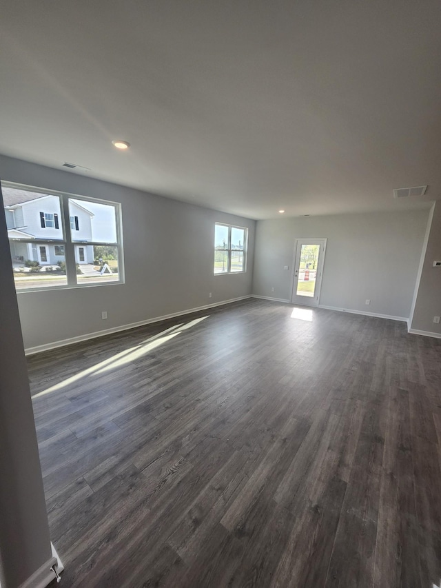 spare room with dark wood-style floors, baseboards, and recessed lighting