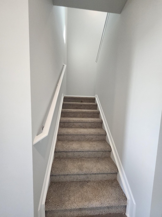 staircase with carpet flooring and baseboards