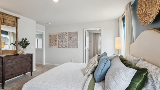bedroom featuring carpet flooring, multiple windows, and baseboards